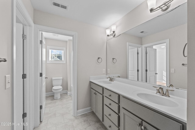 bathroom with toilet and vanity