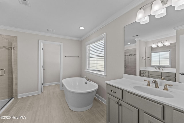 bathroom featuring vanity, crown molding, and shower with separate bathtub