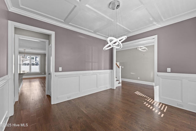 unfurnished dining area with dark hardwood / wood-style flooring, a chandelier, and coffered ceiling