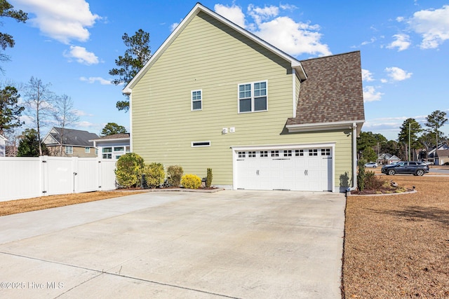 view of side of home featuring a garage