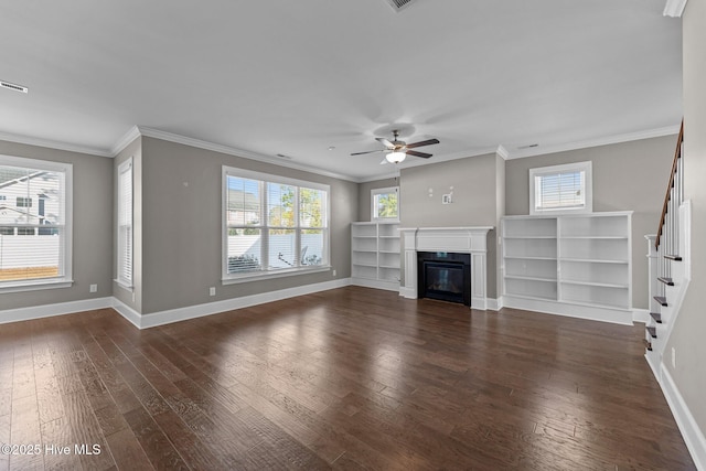 unfurnished living room with a healthy amount of sunlight, ceiling fan, crown molding, and dark hardwood / wood-style flooring