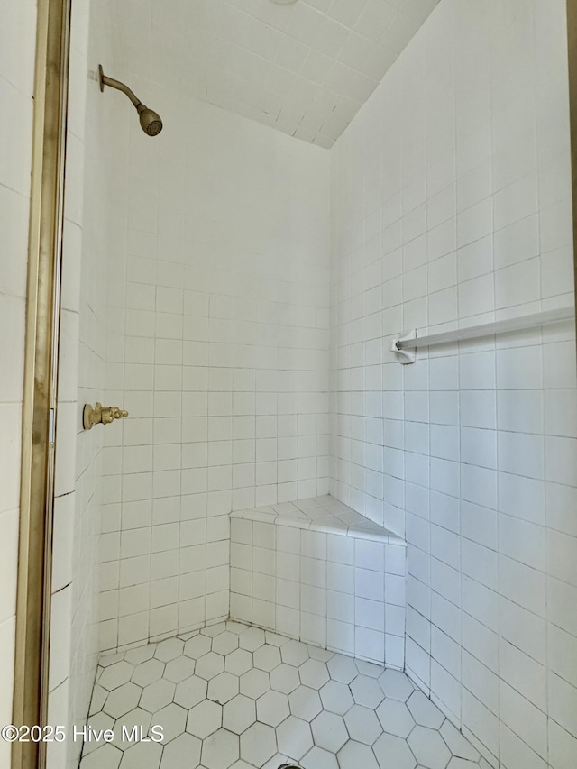 bathroom with tiled shower