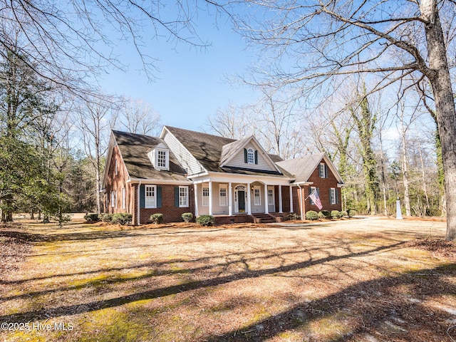 view of front of property featuring covered porch and brick siding