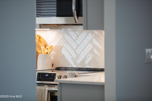 kitchen featuring stainless steel appliances and backsplash