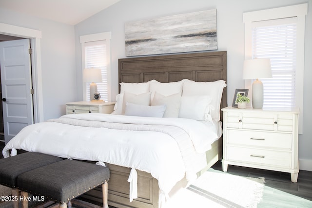 bedroom with lofted ceiling and dark wood-type flooring