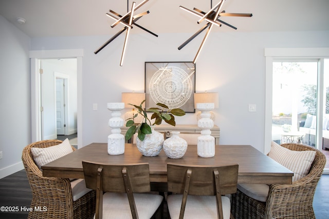 dining space featuring dark hardwood / wood-style floors and a notable chandelier