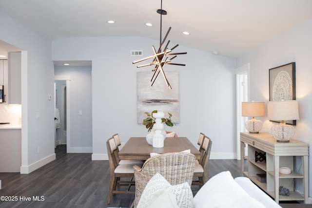 dining space with an inviting chandelier, dark wood-type flooring, and vaulted ceiling