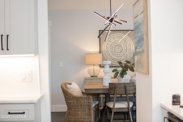 dining room with hardwood / wood-style flooring and an inviting chandelier