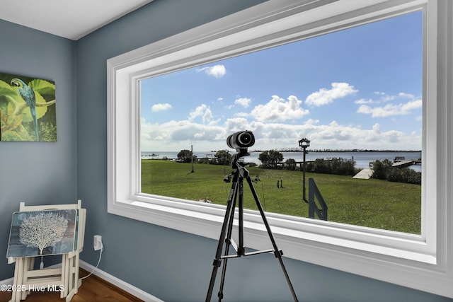 interior space featuring a water view and baseboards