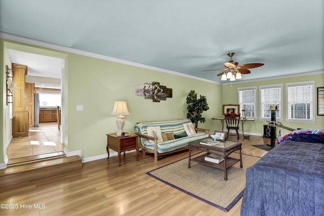 bedroom with multiple windows, crown molding, and light wood-style flooring