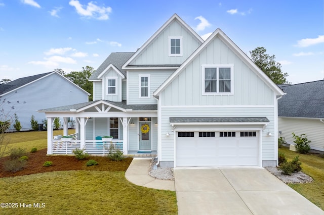 view of front of house featuring a garage, covered porch, and a front lawn