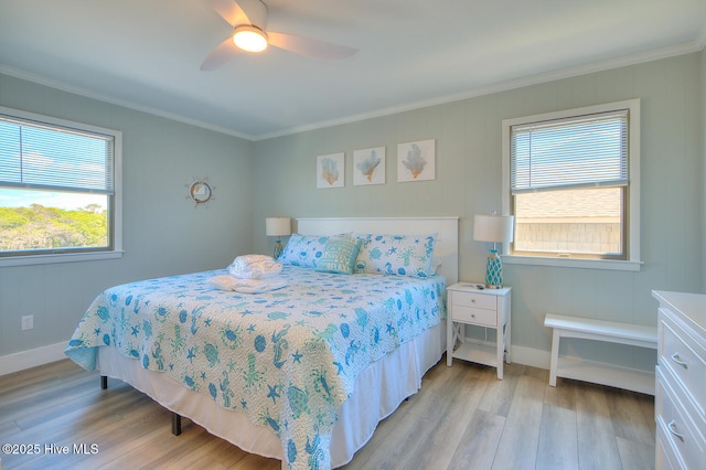 bedroom featuring ornamental molding, light hardwood / wood-style floors, and multiple windows