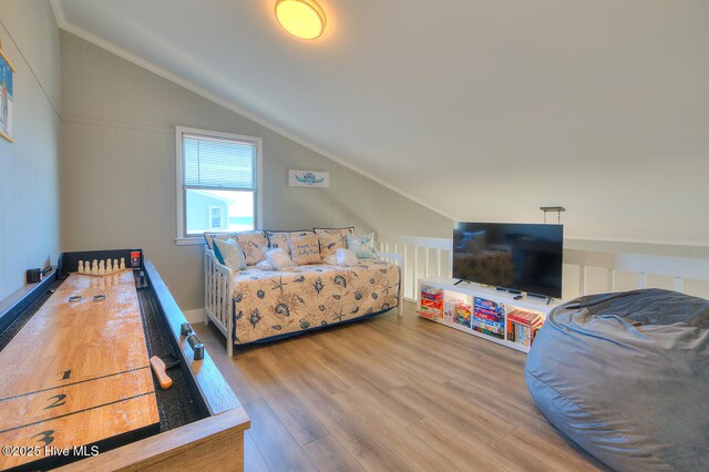 bedroom with lofted ceiling and wood-type flooring