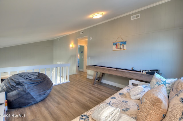 rec room with crown molding, vaulted ceiling, and hardwood / wood-style flooring