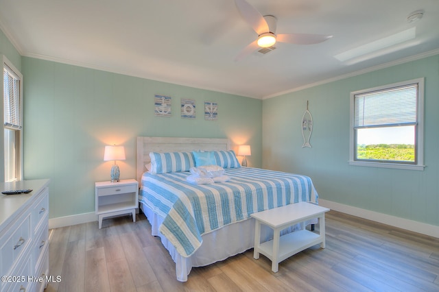 bedroom with crown molding, light hardwood / wood-style flooring, and ceiling fan