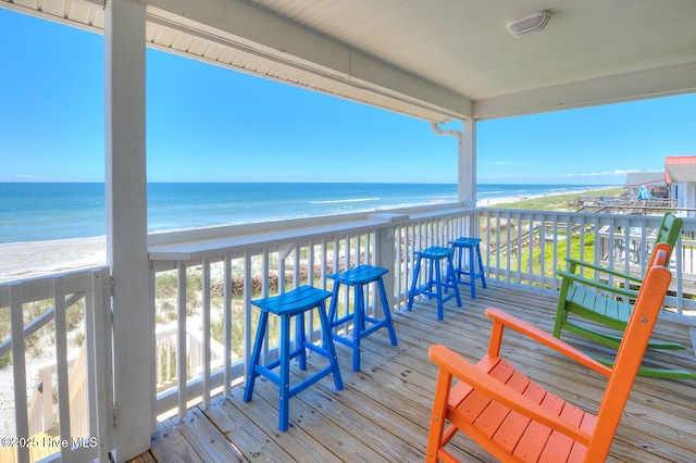 wooden terrace with a beach view and a water view