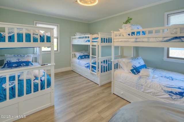 bedroom with ornamental molding and light wood-type flooring