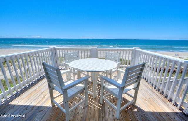 wooden terrace with a view of the beach and a water view