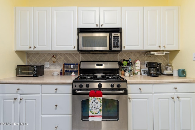 kitchen featuring backsplash, stainless steel appliances, and white cabinets