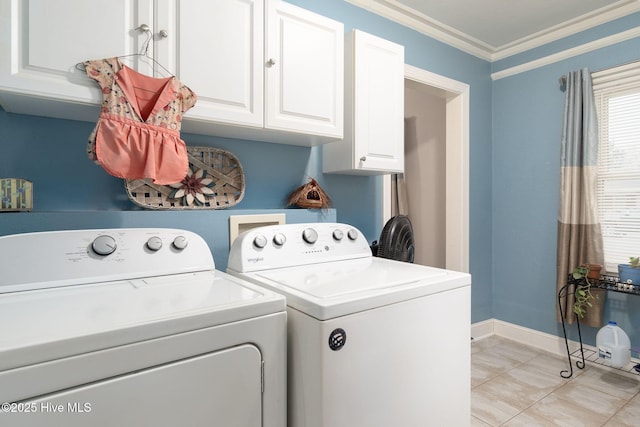 washroom featuring cabinets, crown molding, and washing machine and clothes dryer