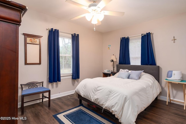 bedroom with dark hardwood / wood-style floors and ceiling fan