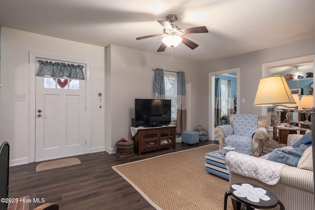 living room with ceiling fan, dark hardwood / wood-style flooring, and a wealth of natural light