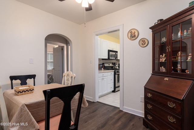 dining space with hardwood / wood-style flooring and ceiling fan