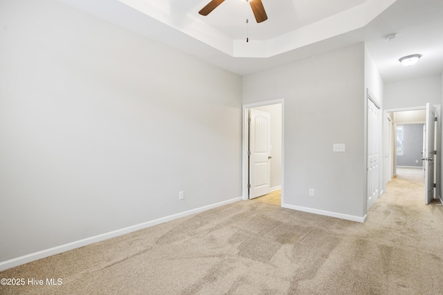 1180 Red Bay Pl, Leland, NC 28451 - unfurnished bedroom featuring light colored carpet, a raised ceiling, baseboards, and ceiling fan