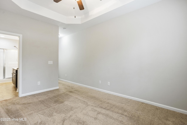 1180 Red Bay Pl, Leland, NC 28451 - spare room with ceiling fan, light carpet, baseboards, and a raised ceiling