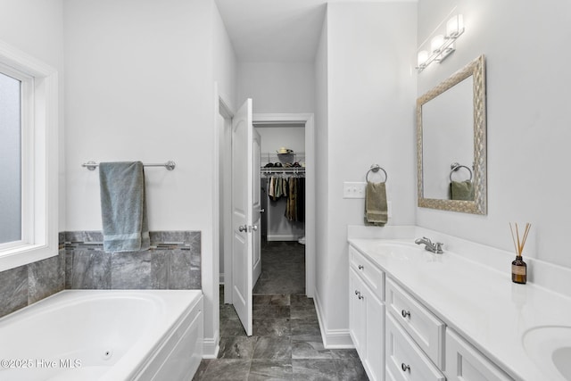 bathroom with vanity, plenty of natural light, and a tub