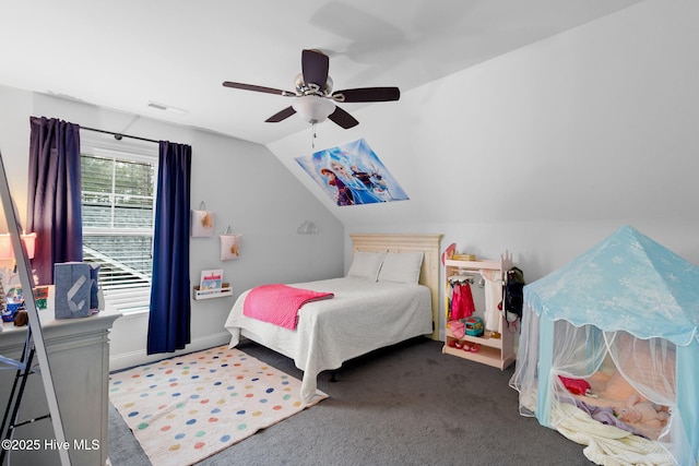 bedroom with lofted ceiling, dark carpet, and ceiling fan