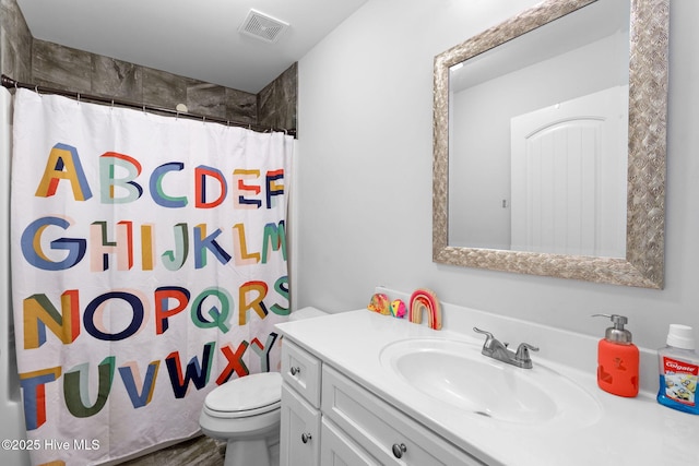 bathroom featuring vanity, a shower with shower curtain, and toilet