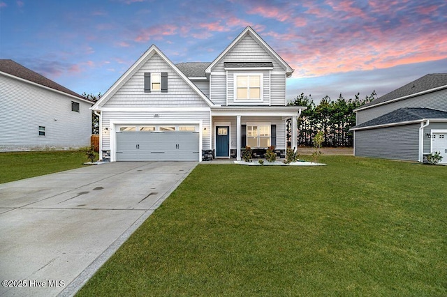 view of front of house with a porch, a yard, and a garage