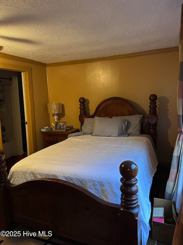 bedroom featuring a textured ceiling and crown molding