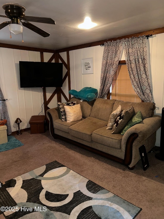 carpeted living area with ceiling fan