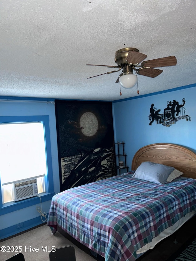 bedroom with a ceiling fan, cooling unit, carpet, and a textured ceiling