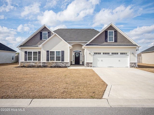 craftsman house with a garage and a front yard