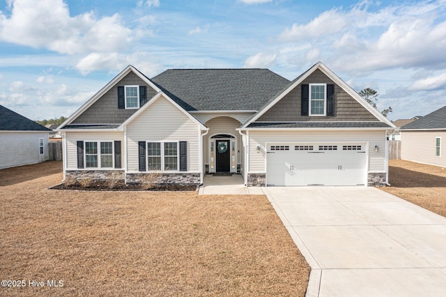 craftsman-style home featuring a garage and a front yard