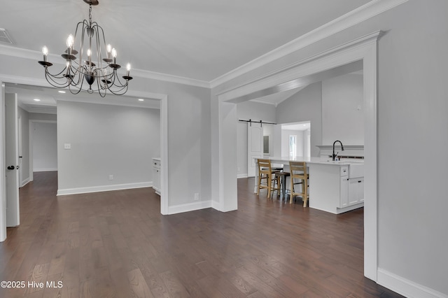 unfurnished dining area featuring a barn door, dark wood-type flooring, visible vents, and crown molding