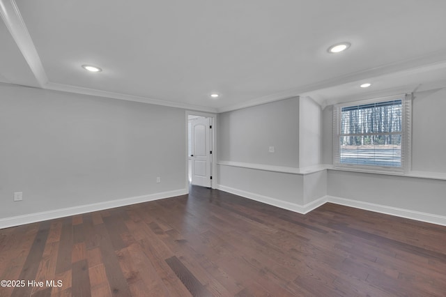 spare room with ornamental molding, dark wood-style flooring, recessed lighting, and baseboards