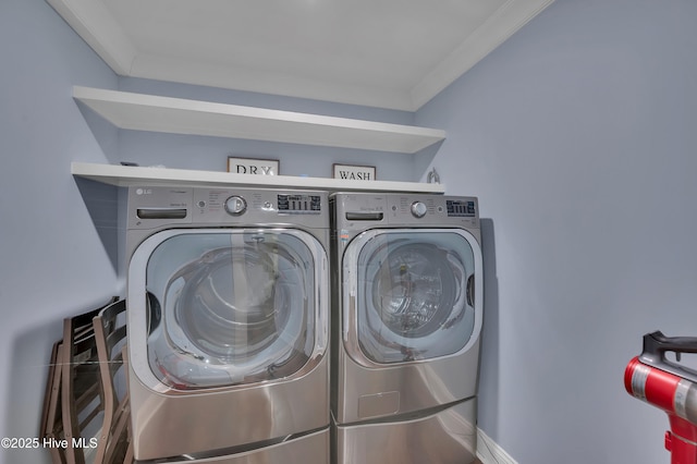 laundry area featuring washing machine and dryer, laundry area, and crown molding