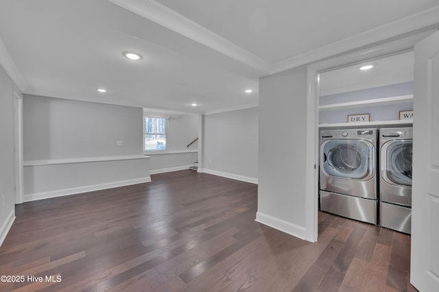 washroom featuring dark wood-style flooring, washer and clothes dryer, ornamental molding, laundry area, and baseboards