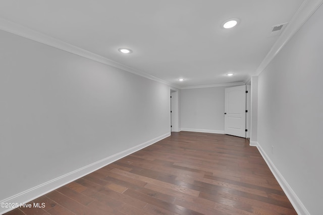 spare room with baseboards, dark wood finished floors, crown molding, and recessed lighting