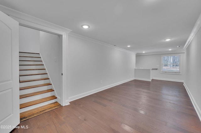 below grade area with recessed lighting, wood finished floors, baseboards, stairs, and crown molding