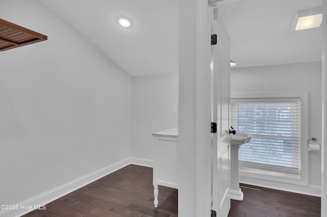 interior space with lofted ceiling and dark wood finished floors