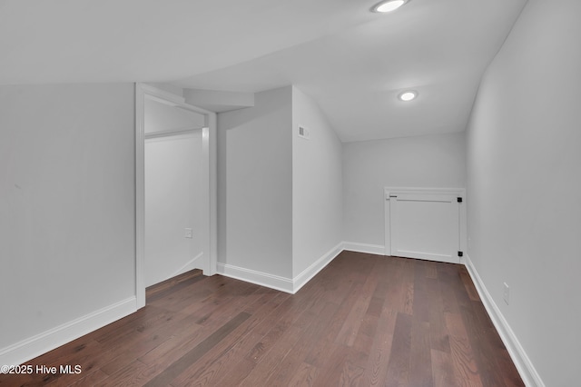 additional living space featuring dark wood-style floors, recessed lighting, visible vents, and baseboards