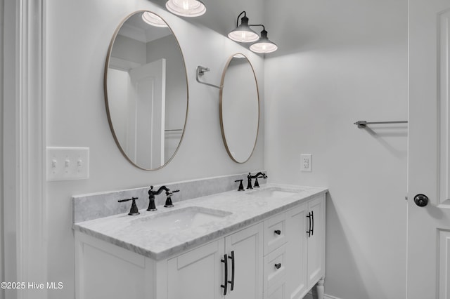 full bathroom featuring a sink and double vanity