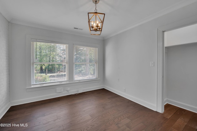 empty room featuring a notable chandelier, dark wood-style flooring, visible vents, baseboards, and crown molding