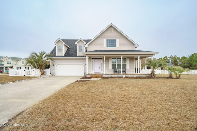 view of front of home with driveway, a garage, covered porch, fence, and a front lawn