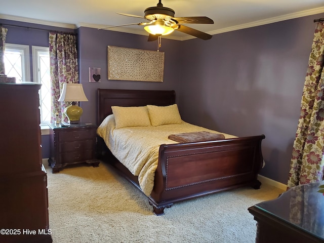 bedroom with carpet floors, ceiling fan, baseboards, and crown molding